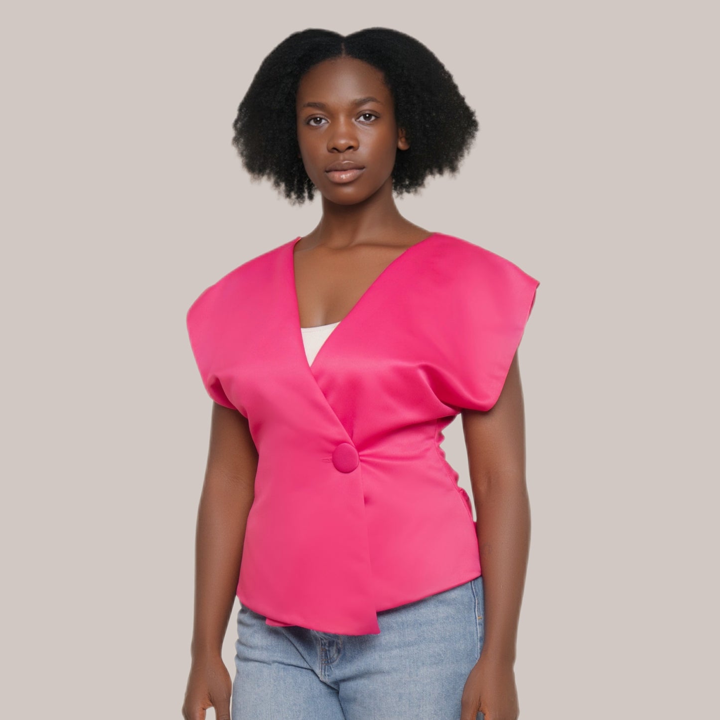 Woman wearing a bright pink top with a plain background